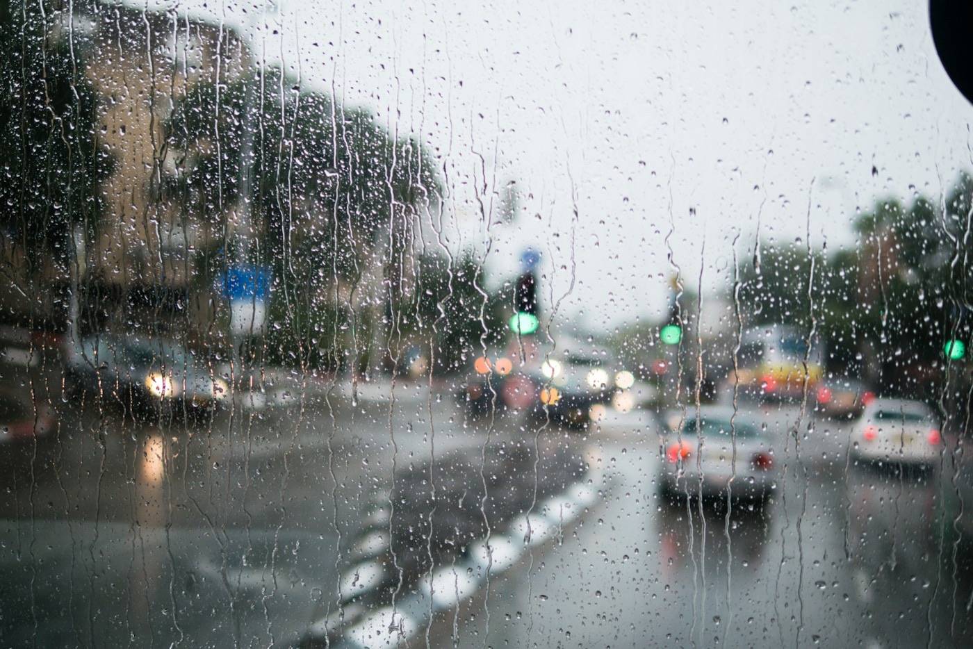 Rain on a windshield in city traffic