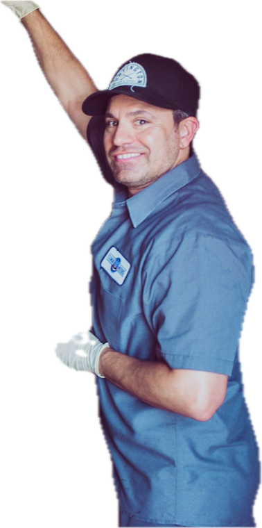 A smiling mechanic in a blue work shirt